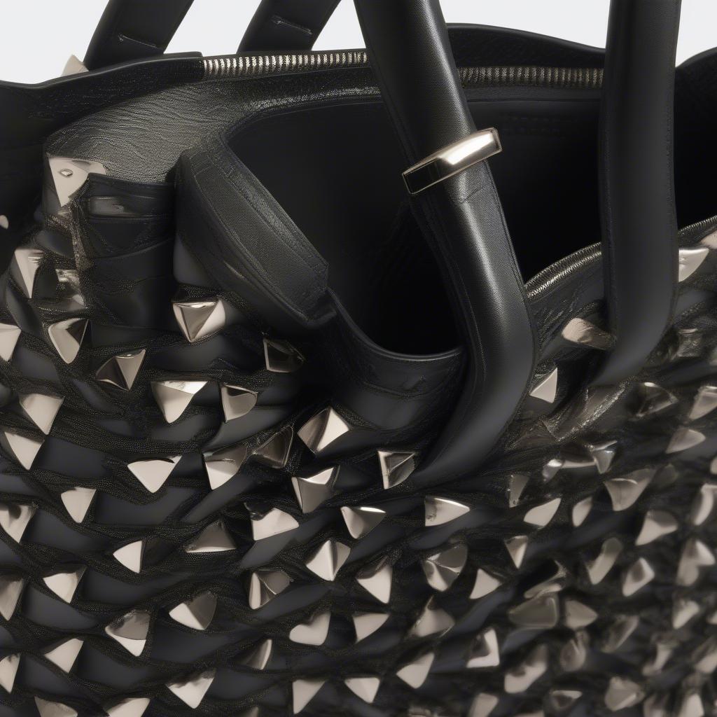 Close-up of the Jimmy Choo Maxine Woven Studded Tote