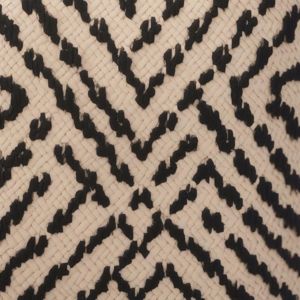 Close-up view of the woven spade pattern on the Kate Spade Nadine bag