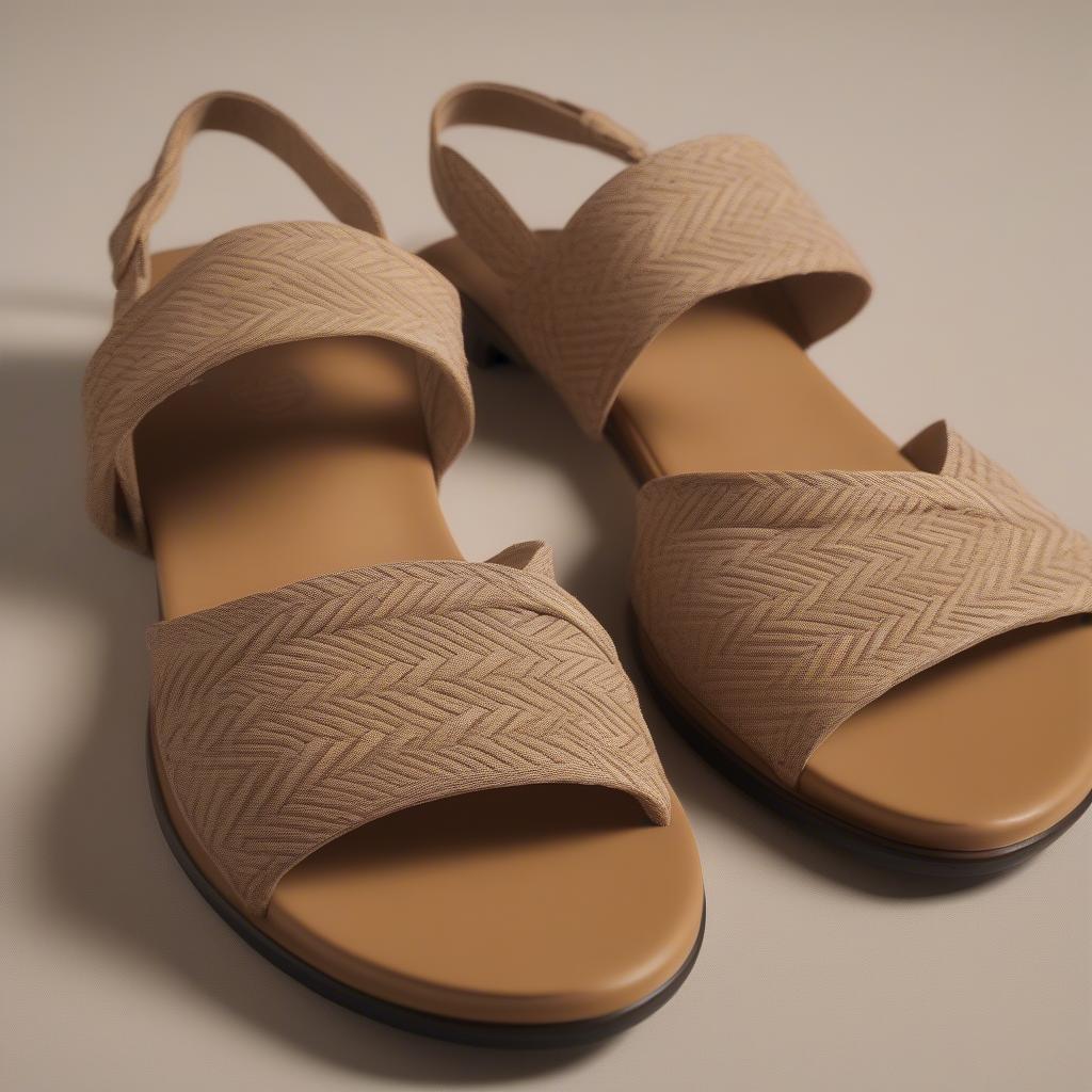 Close-up of the Kate Spade Tilly Basket-Weave Wedge Sandals showcasing the intricate detailing and texture