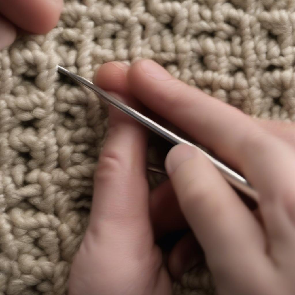 Left-handed crocheter demonstrating the basic steps of the basket weave stitch, showing the yarn over and hook placement.