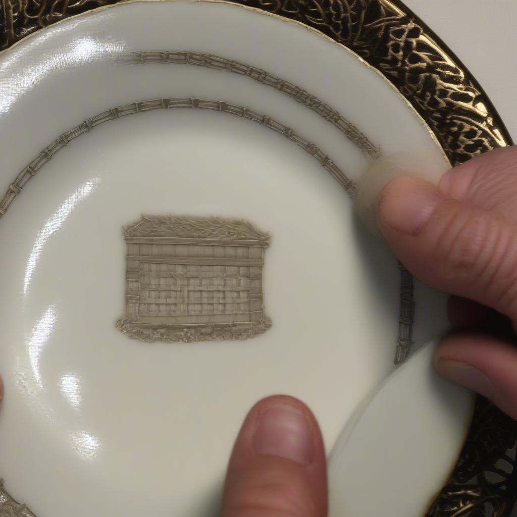 An antique appraiser examining a piece of Lenox basket weave china.