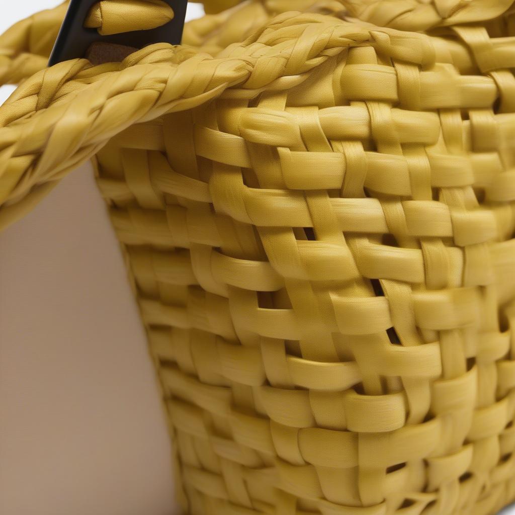 Close-up of the Marni Yellow Mini Woven Shopping Bag showcasing the intricate woven details and vibrant yellow color.