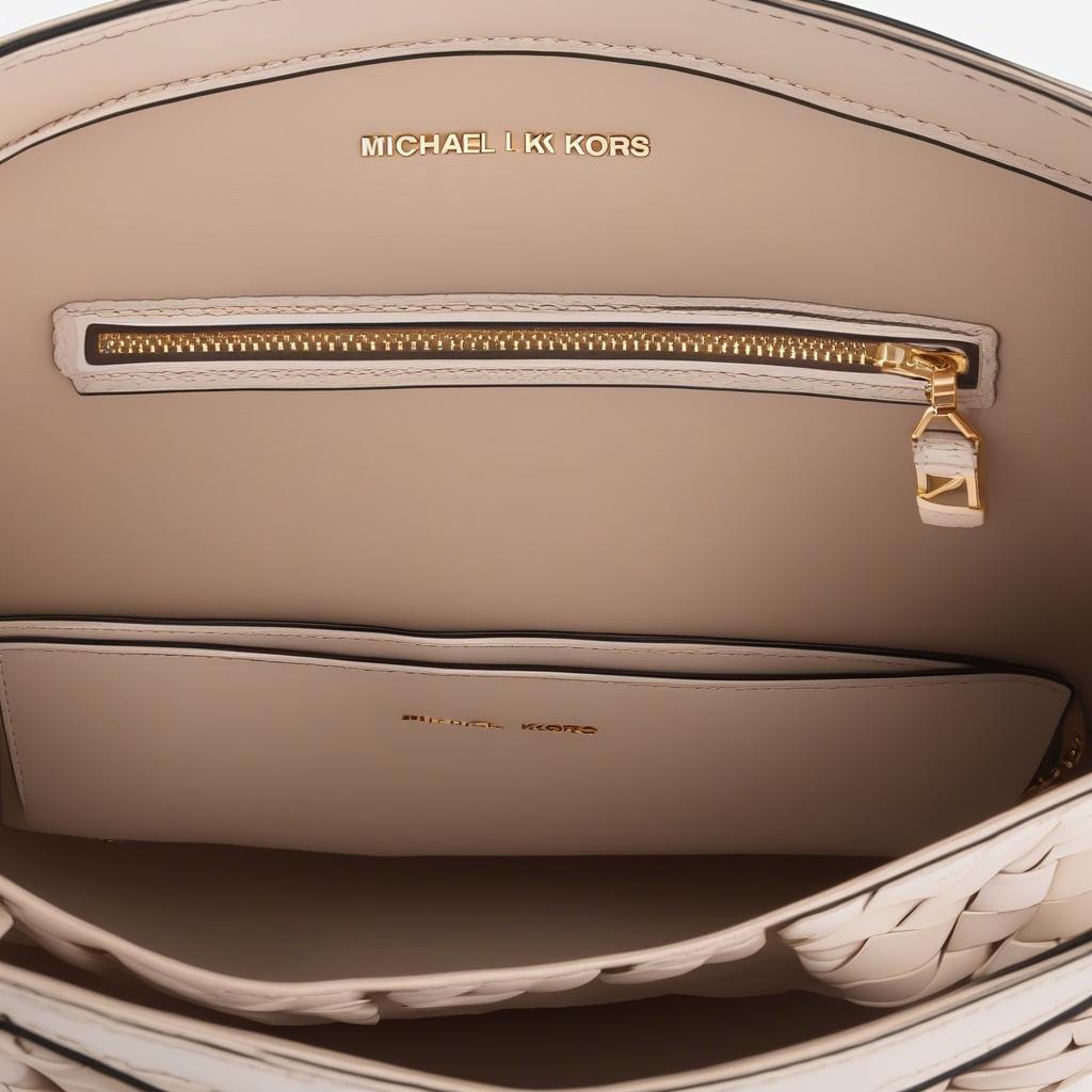 Inside view of the Michael Michael Kors Ivy Large Woven Crossbody Bag, showcasing its lining, pockets, and spacious interior.