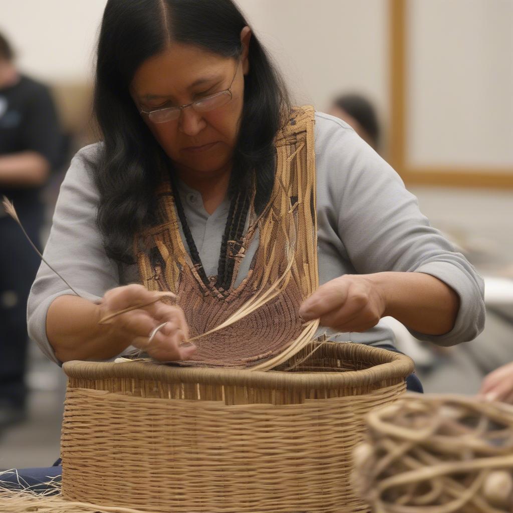 Native American basket weaver demonstrating techniques at the 2019 conference