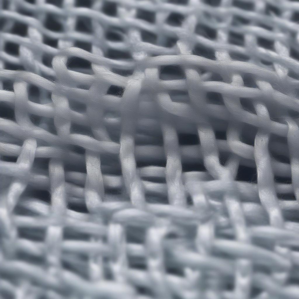 Close-up of non-woven bag material showing the interlocked fibers.