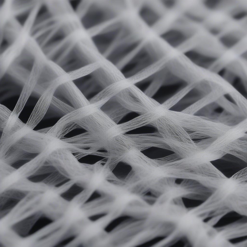 Non-Woven Fabric Structure: A microscopic view of the fibers bonded together.