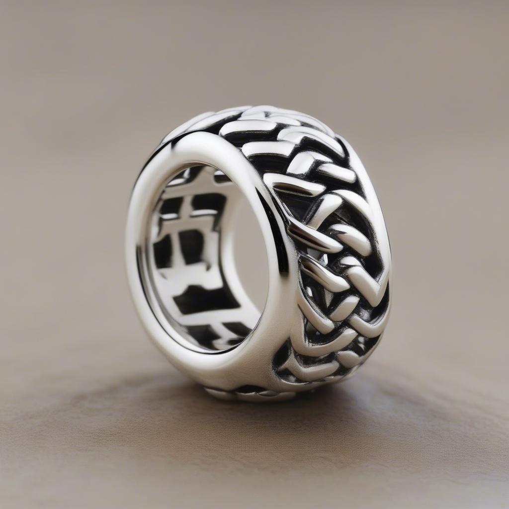 Close-up of an open basket weave Pandora charm showing the intricate details of the weaving pattern