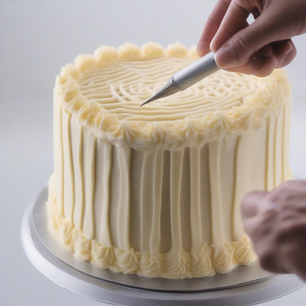 Piping buttercream frosting onto a cake to create a basket weave design