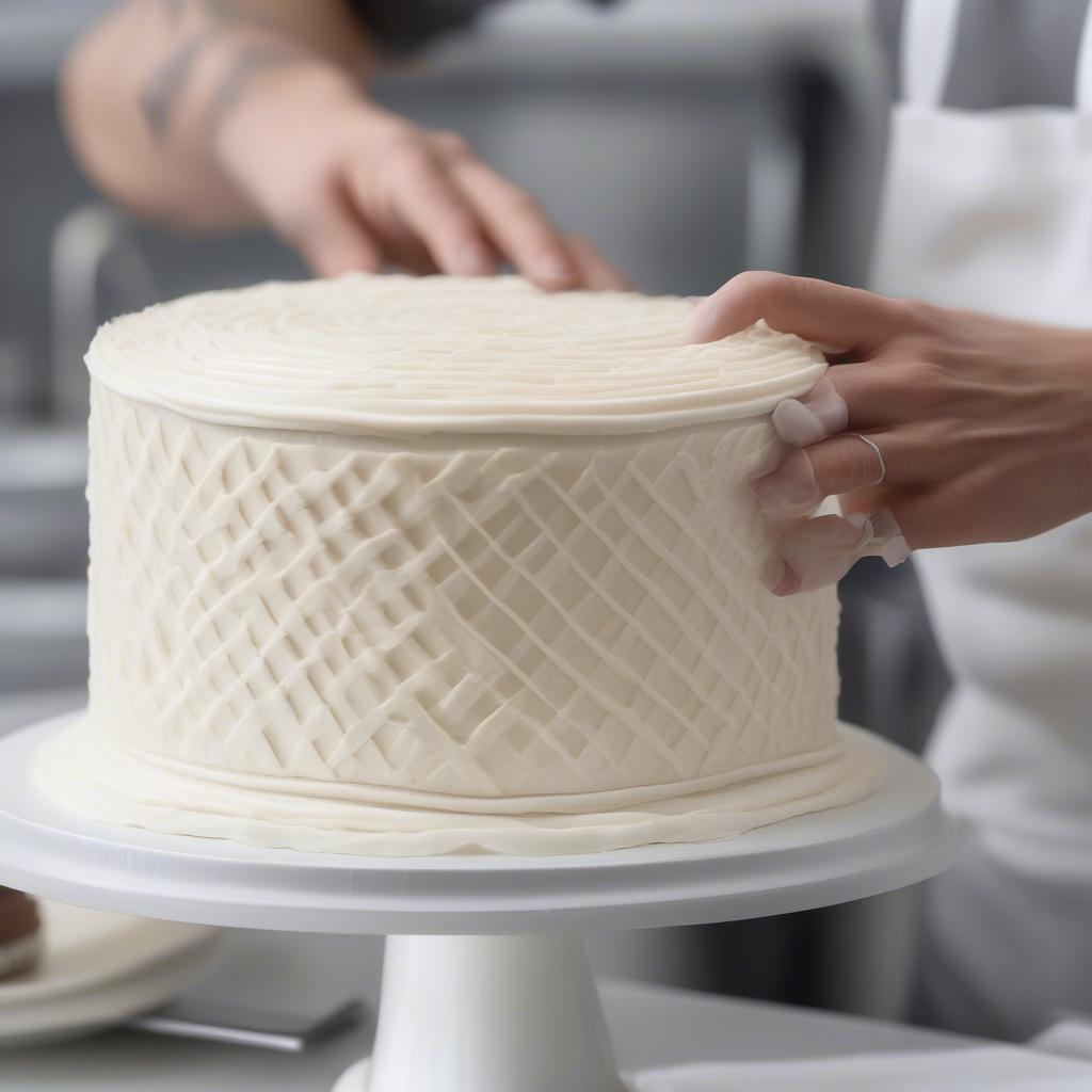 Piping a basket weave pattern onto a cake using a piping bag and tip