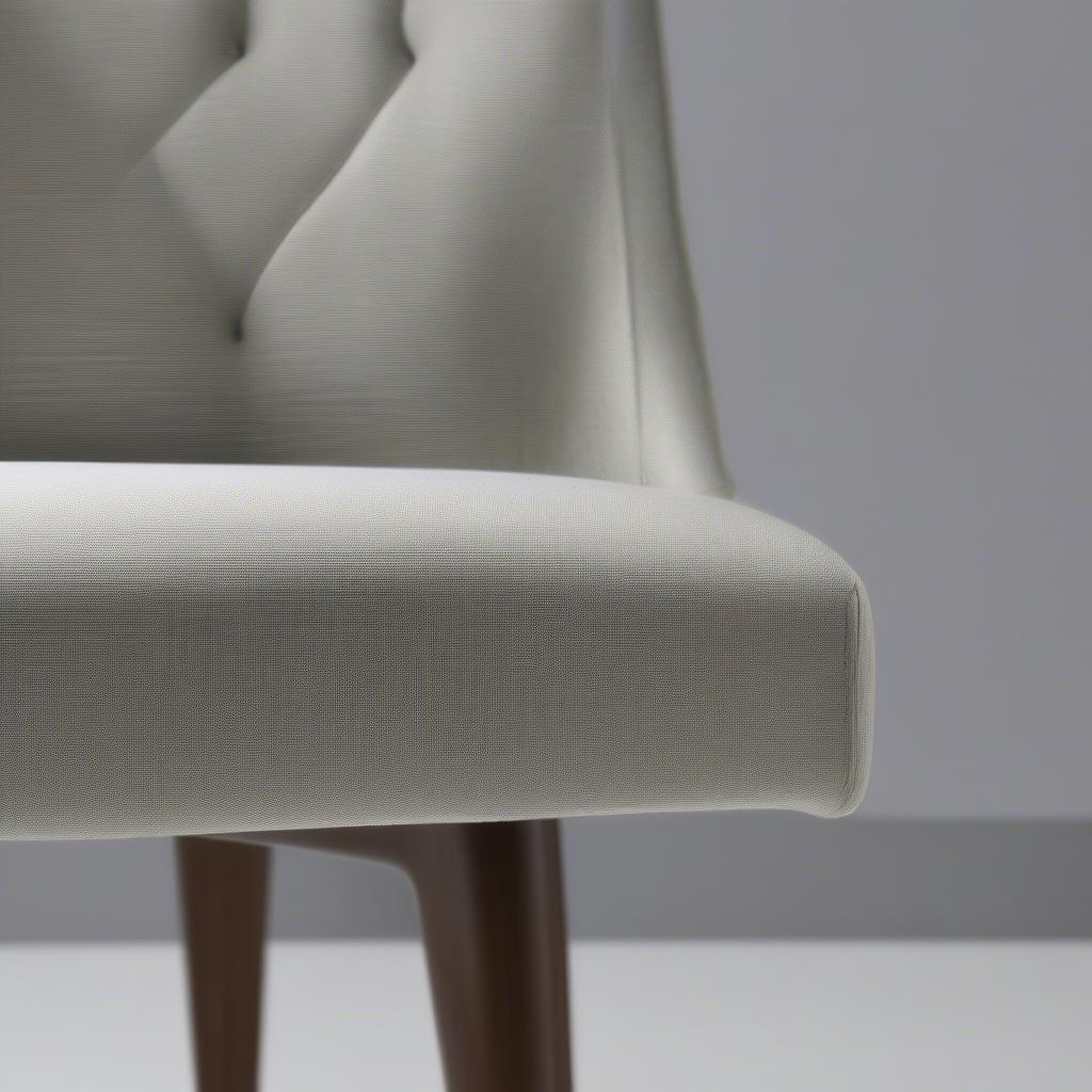 Close-up of Platinum Linen Weave Upholstery and Tapered Legs on a Mid Century Dining Chair