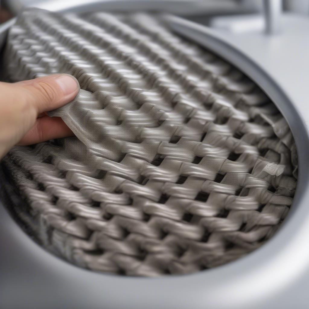 Polishing basket weave stainless steel with a microfiber cloth to restore shine and luster.