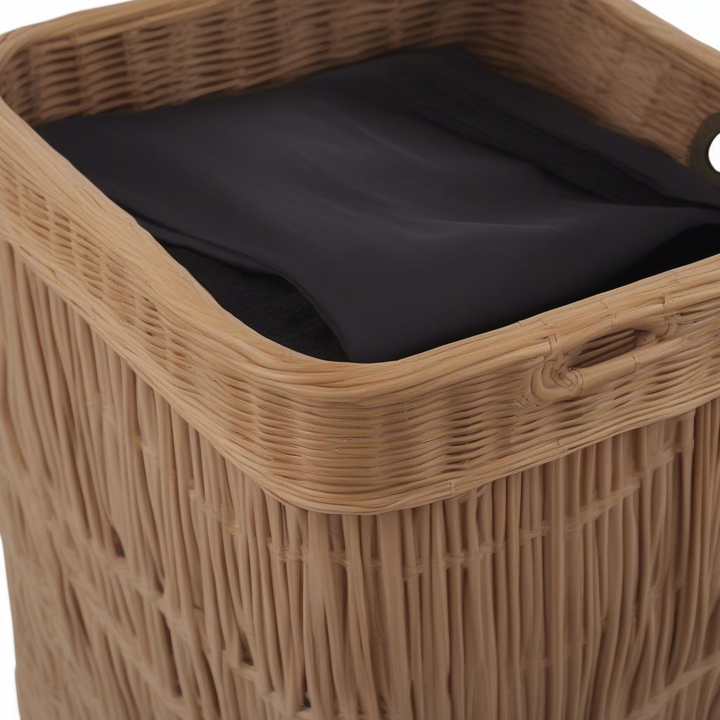 A rattan laundry hamper featuring a removable liner