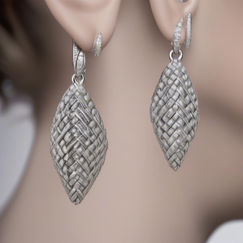 Close-up view of Scott Kay basket weave drop earrings showcasing the intricate details of the weave and the sparkle of diamonds.