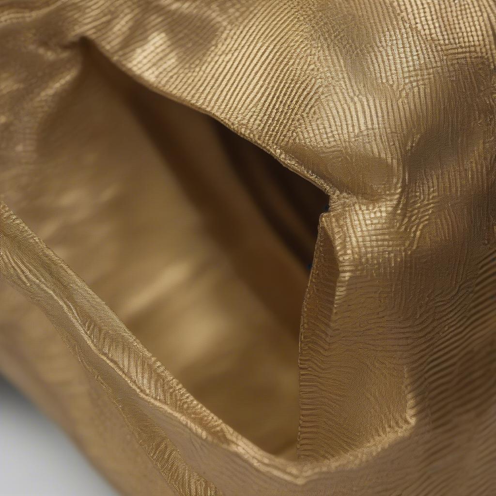 Close-up of the Shakira Gold Woven Shopper Bag