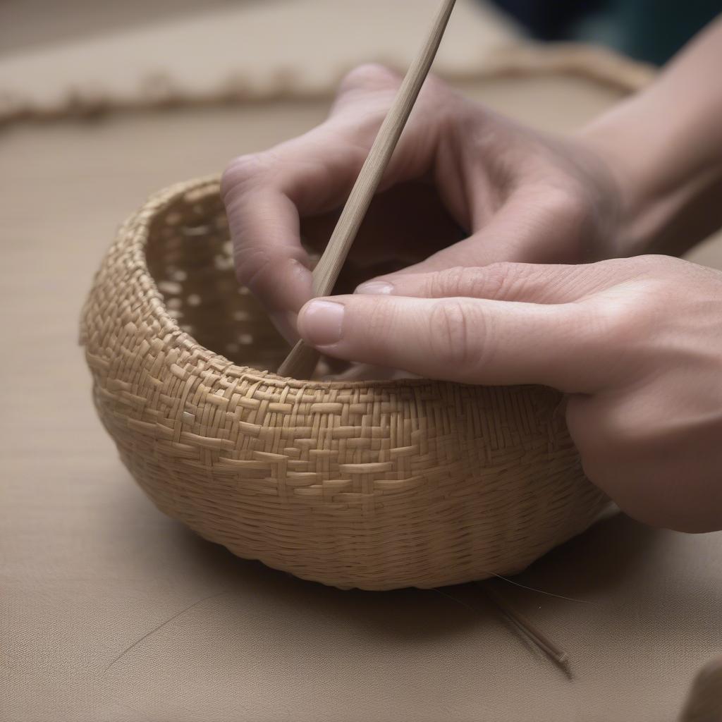 Shaping a small woven basket using hands and tools