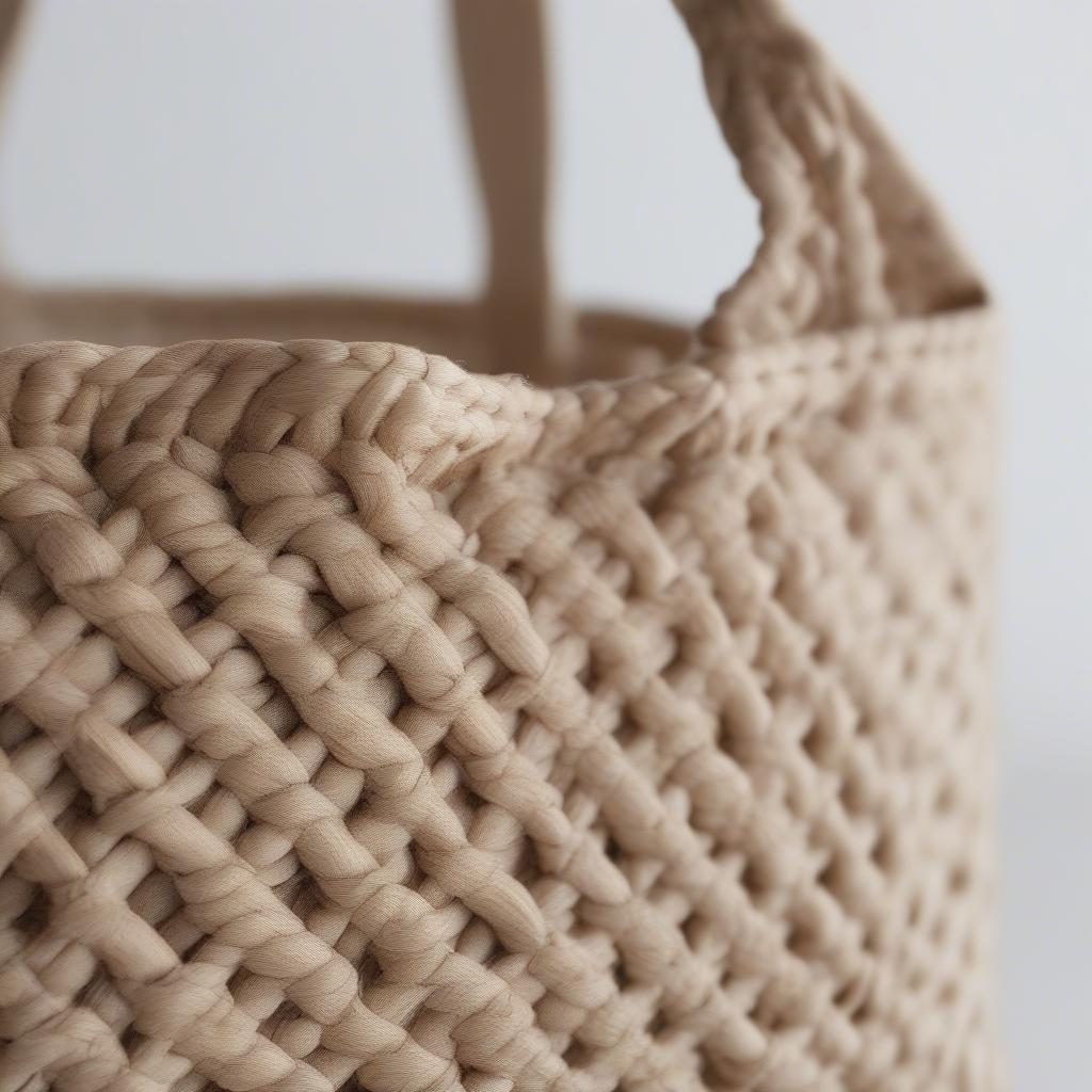 Small woven tote bag made of natural fibers like jute or seagrass