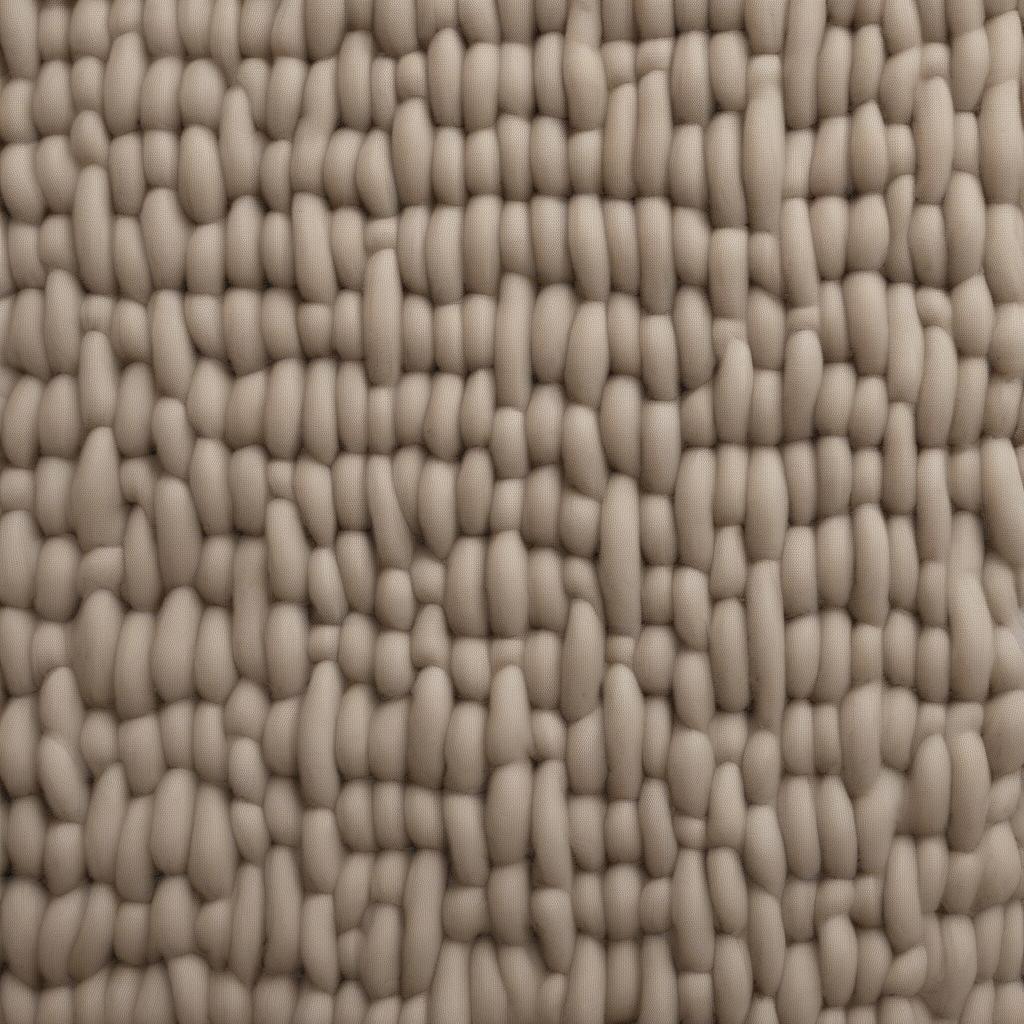 Close-up view of a solid angled basket weave wool rug, showcasing the intricate texture and craftsmanship