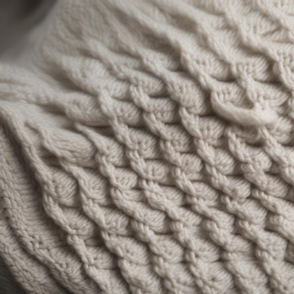 Close-up view of the teeberry and weave basket textured cardigan showing the intricate basket weave stitch detail