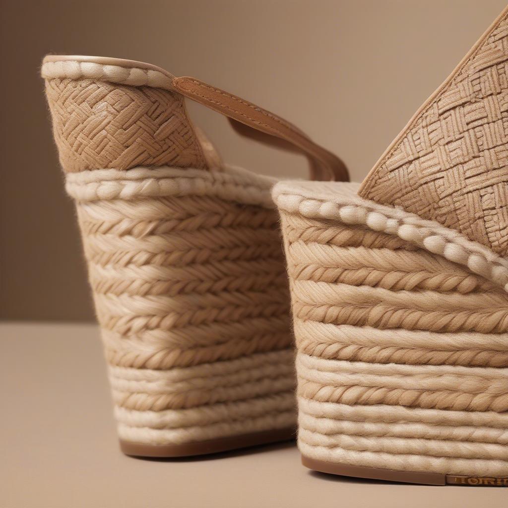 Close-up view of the Tory Burch Basket Weave Espadrille Wedge, highlighting the intricate basket weave pattern and the espadrille sole.