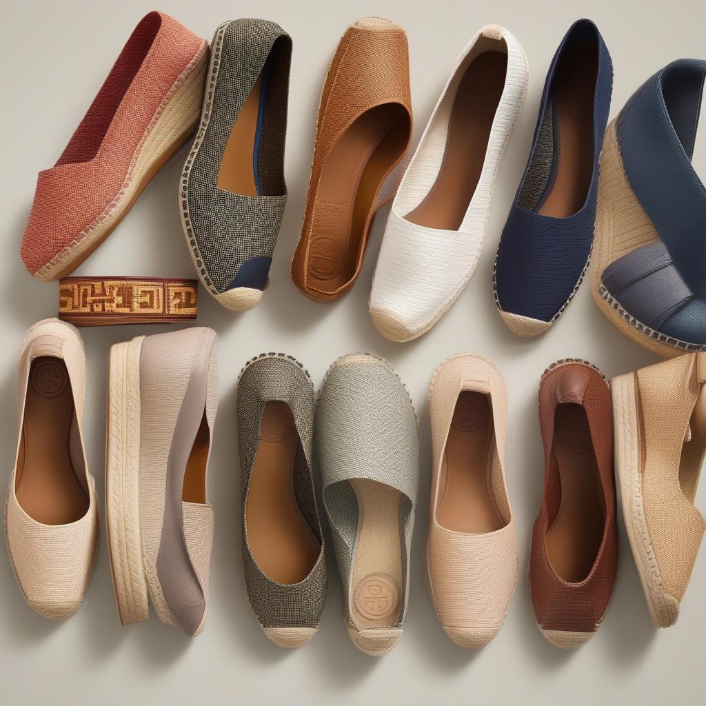 A display of Tory Burch Basket Weave Espadrille Wedges in various colors and materials, showcasing the range of options available.