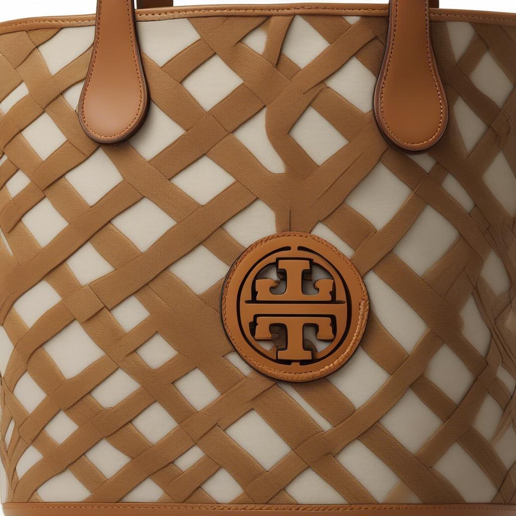 Close-up of the Tory Burch Canvas Basket Weave Small Tote showcasing the intricate weave detail and the signature logo.