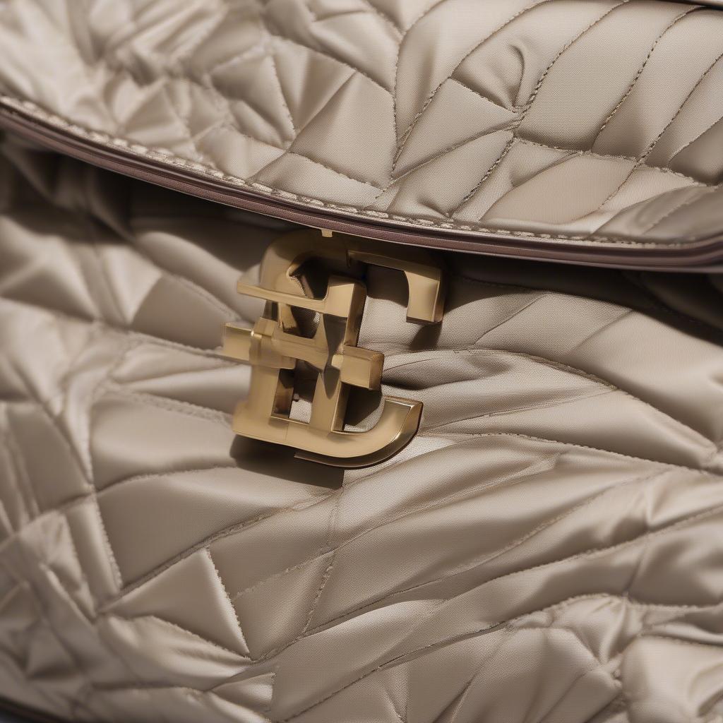 Detailed view of the Tory Burch Kira Mini Woven Satin Shoulder Bag's satin weave, interior lining, and hardware.