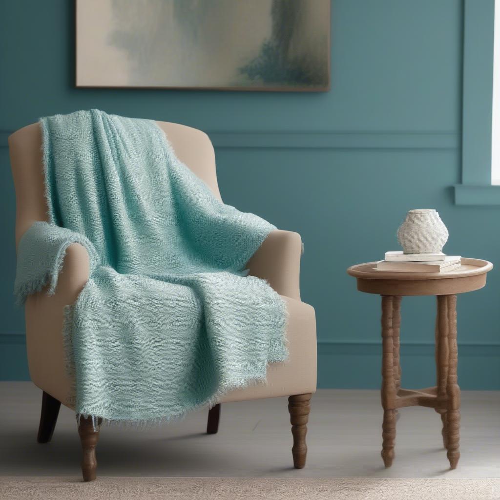 Turquoise slub weave English arm chair styled with a throw blanket and a side table