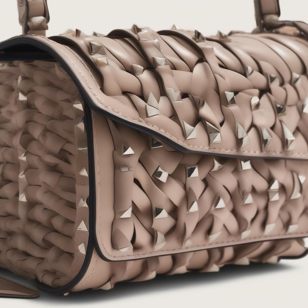 Close-up of the Woven Strap on the Valentino Garavani Rockstud Rolling Shoulder Bag