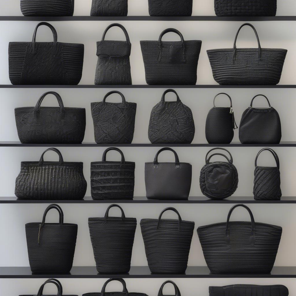 A display of various styles of black woven crossbody bags.